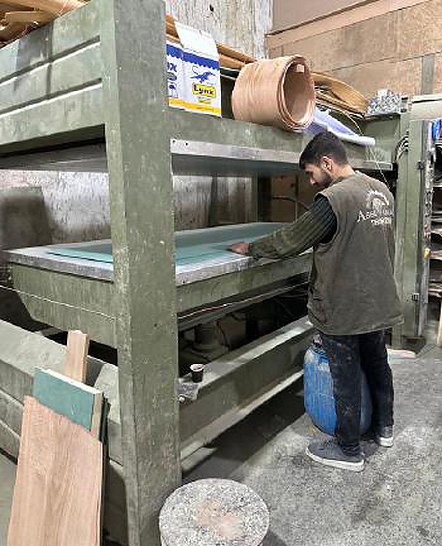 Worker operating CNC machine