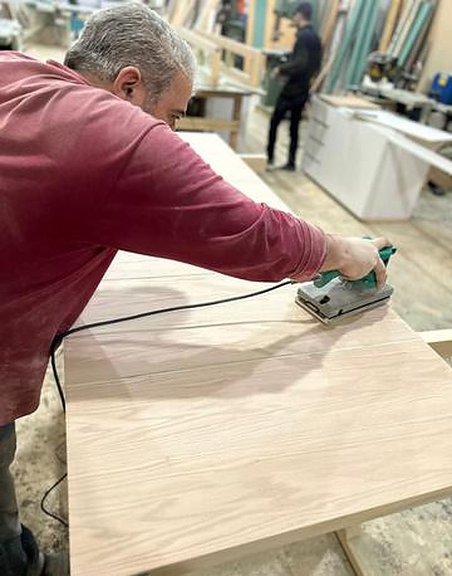 Hand sanding wood surface