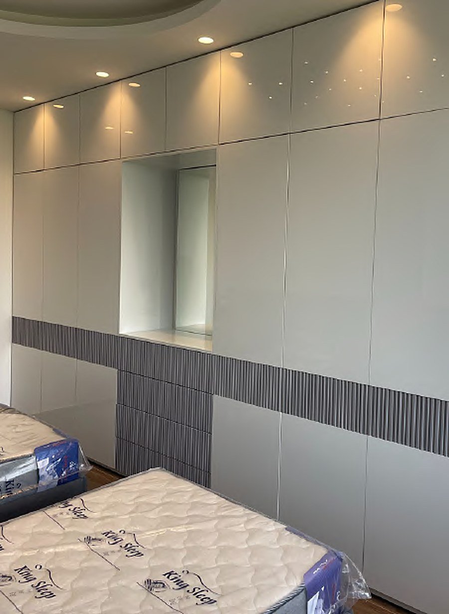 Full wall grey wardrobe with slat accent band