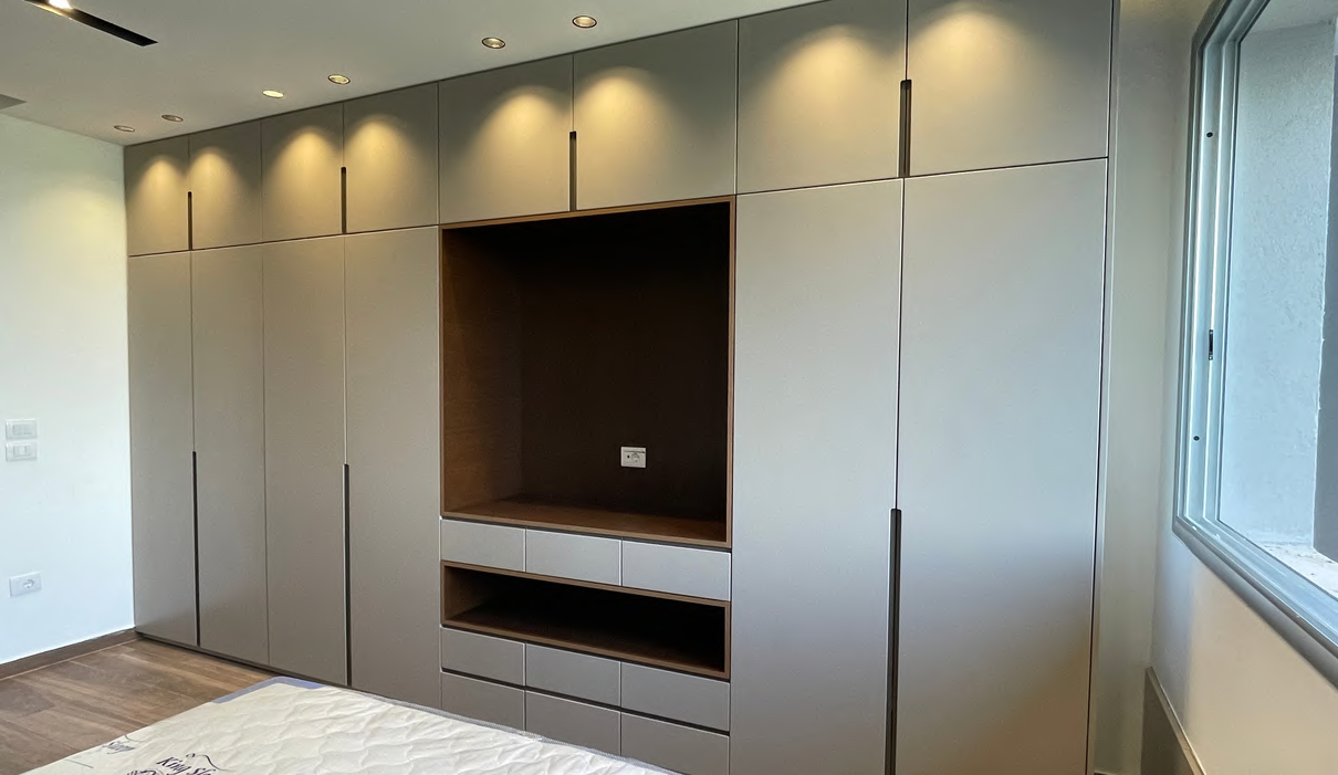 Full wall taupe wardrobe with TV niche