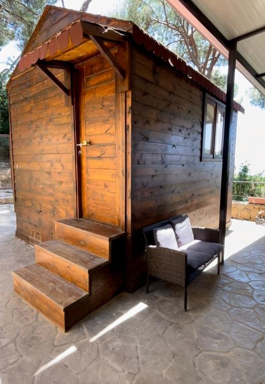 Row of green and grey painted garden bungalows