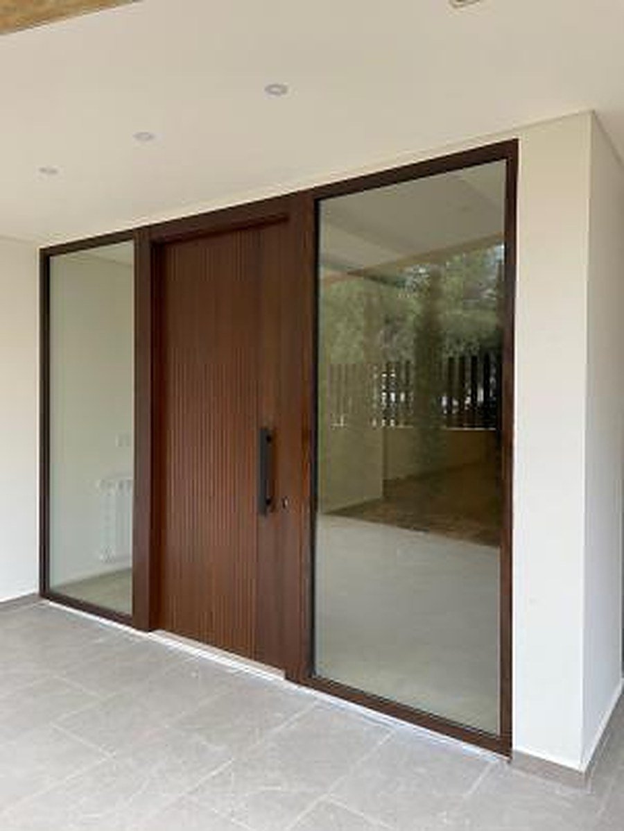 Natural wood entrance door in stone surround
