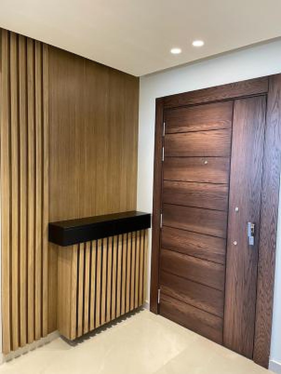 Dark walnut entrance door with slatted frame