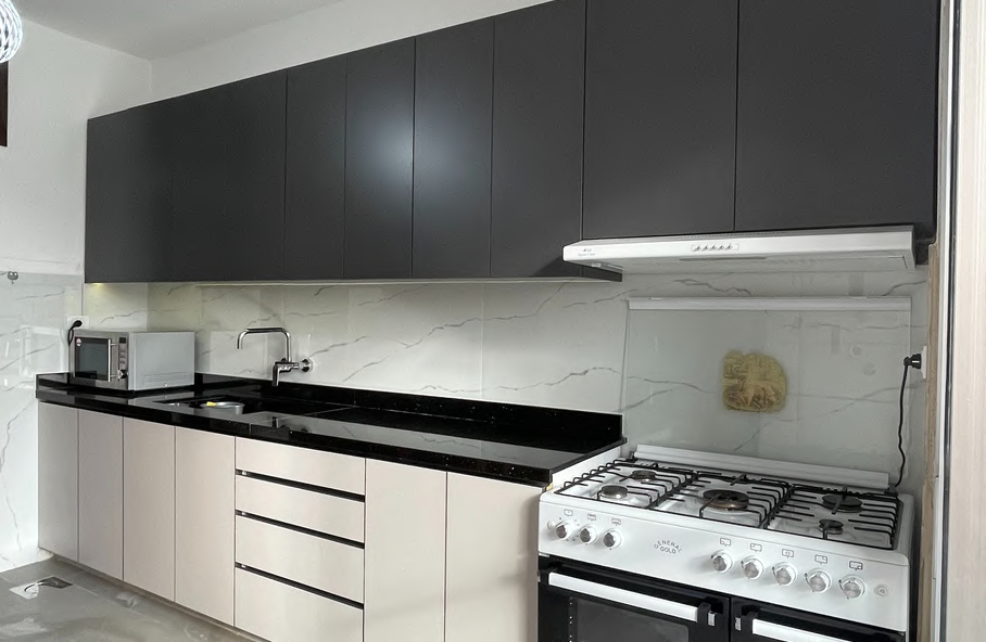 Dark modern kitchen with black granite countertop