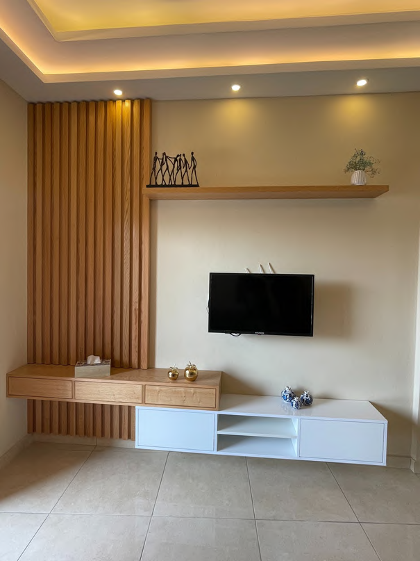 Floating wood TV shelf with warm glow