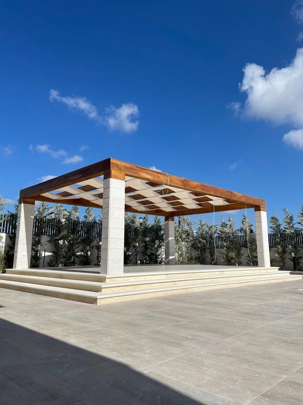 Large flat-roofed pergola on marble terrace