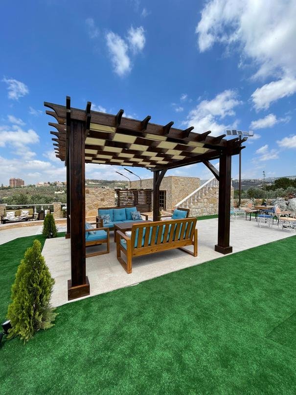 Dark wood garden pergola with lounge seating