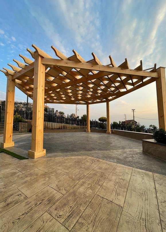 Light cedar sunset pergola on stamped terrace
