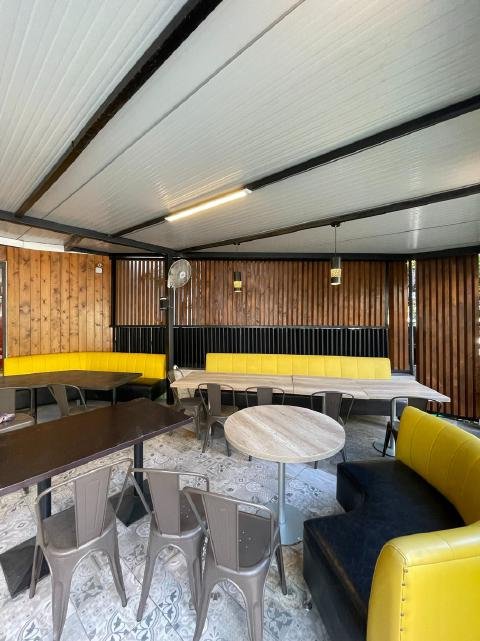 Full restaurant fit-out with cedar walls and yellow booths