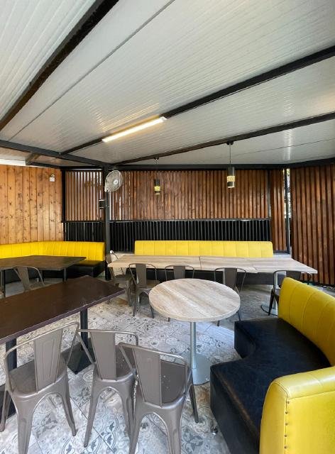 Restaurant interior with ceiling slats and booth seating